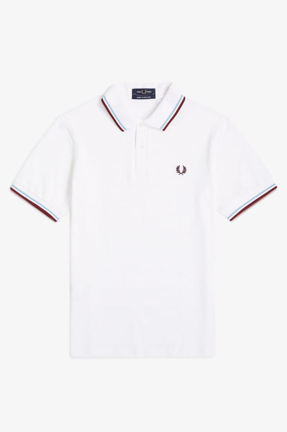 White polo shirt with red and blue trim on a white background