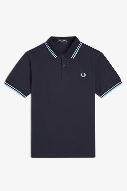Navy polo shirt with white trim on a light gray background