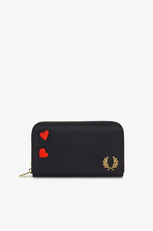 Black wallet with red hearts and a brand logo on a white background