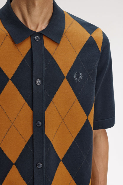 Navy and orange argyle patterned shirt with brand logo on a white background