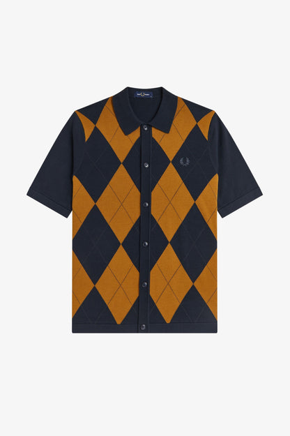 Navy and mustard argyle patterned shirt on a light gray background