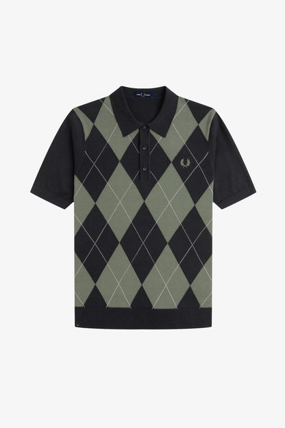 Black and green argyle patterned polo shirt on a white background