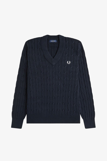 Navy cable knit sweater with a brand logo on a light gray background