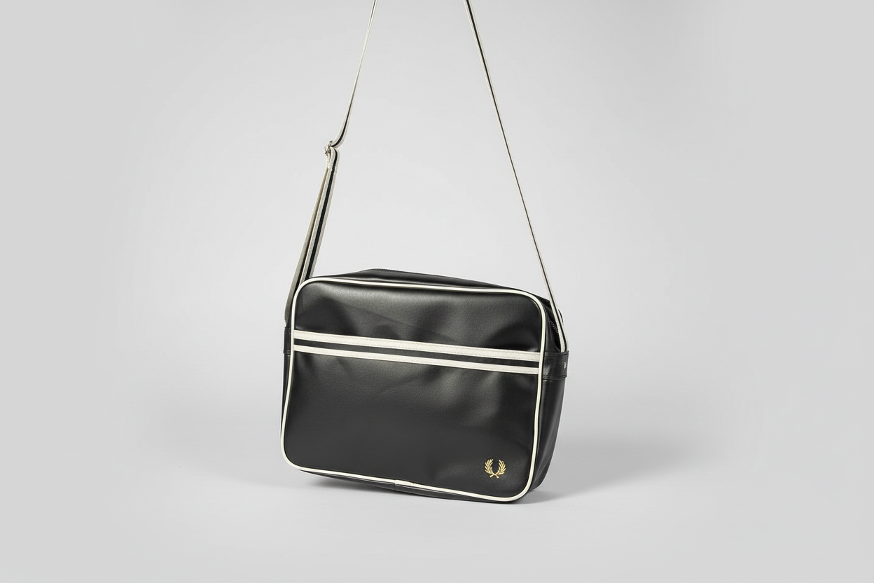 Black shoulder bag with white accents on a light gray background