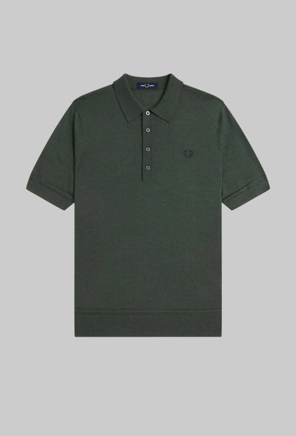 Dark green polo shirt with a small logo on a white background