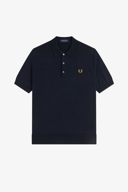 Black polo shirt with a small logo on a white background