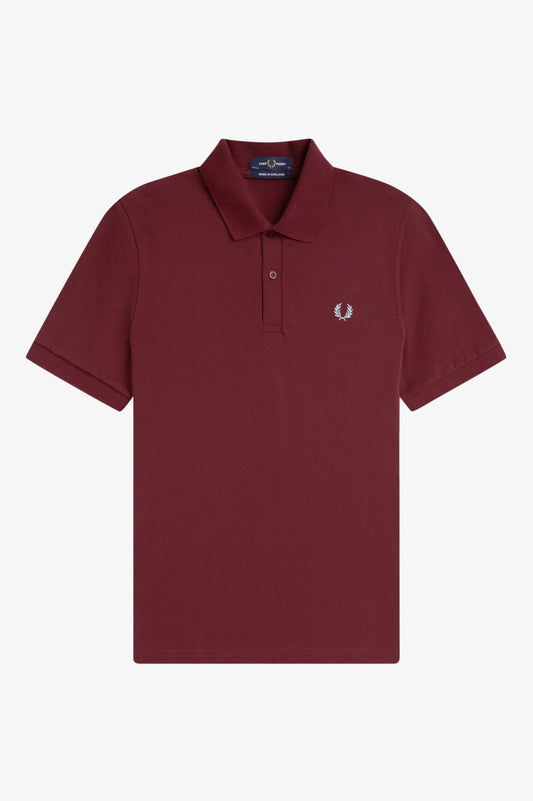 Maroon polo shirt with a small logo on a white background