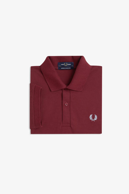 Maroon polo shirt with a brand logo on a light gray background
