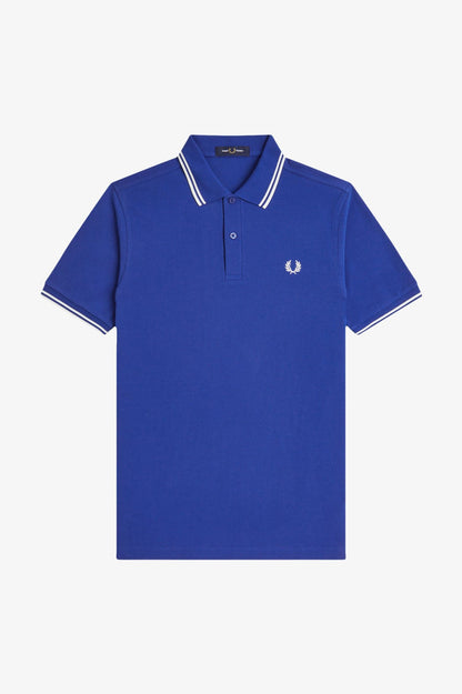 Blue polo shirt with white trim on a light gray background