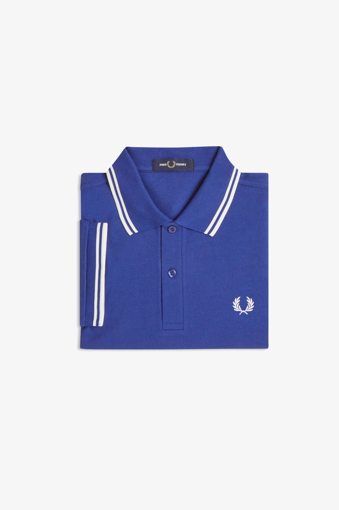 Folded blue polo shirt with white accents on a light gray background