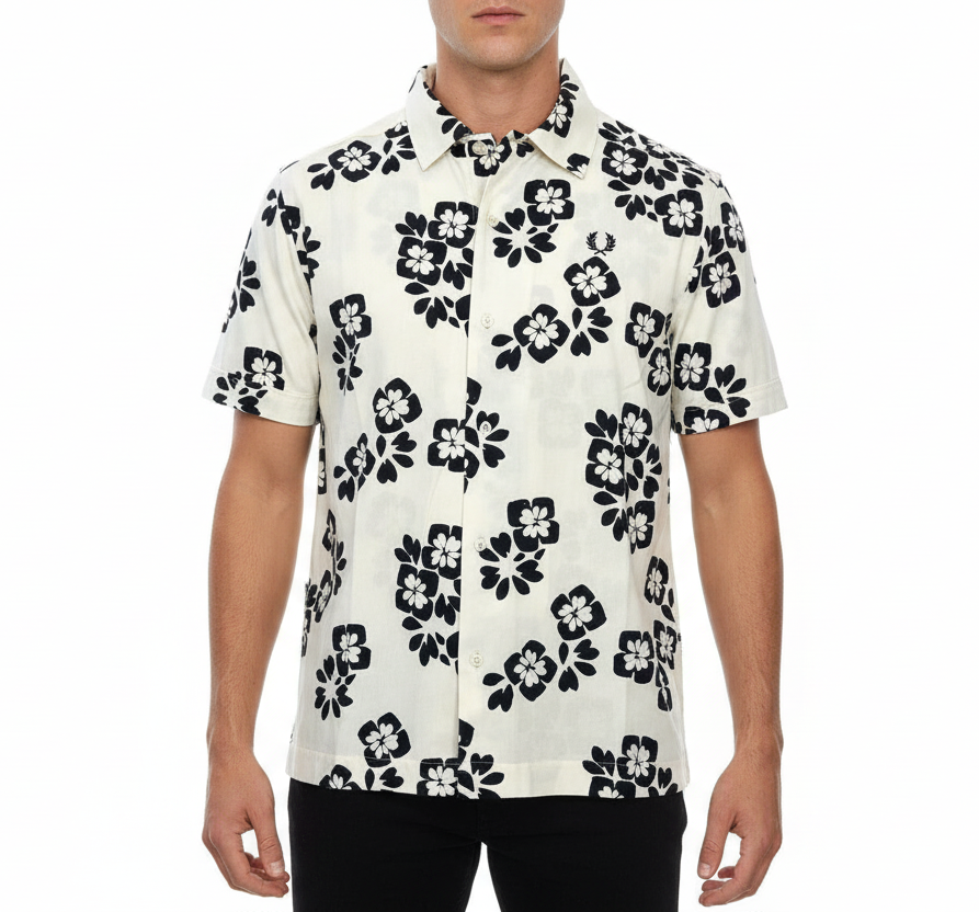 Man wearing a white shirt with black floral pattern on a white background