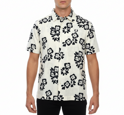 Man wearing a white shirt with black floral pattern on a white background