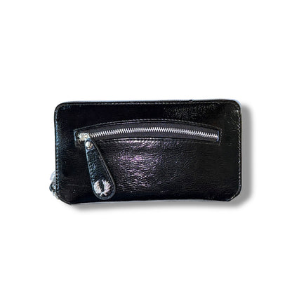 A black patent leather purse with a zipper closure.