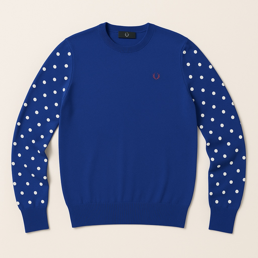 Blue sweater with white polka dot sleeves on a beige background