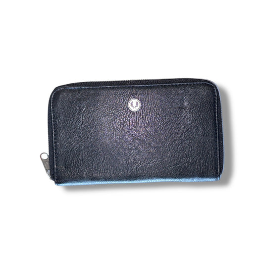 A black leather slimline purse with a visible logo and a zipper closure.