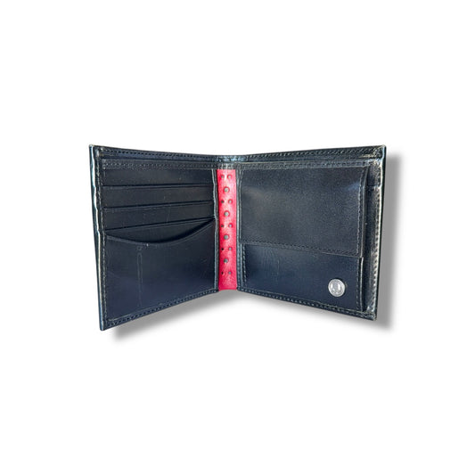 Open black leather wallet with red lining on a white background