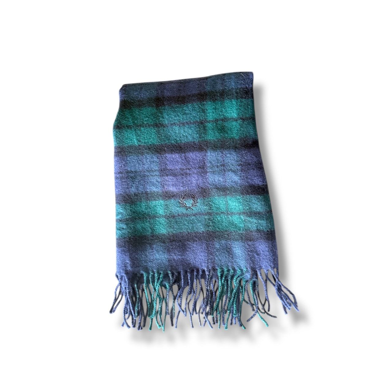 A woven tartan scarf with blue, green, and purple stripes, featuring fringes on the ends.