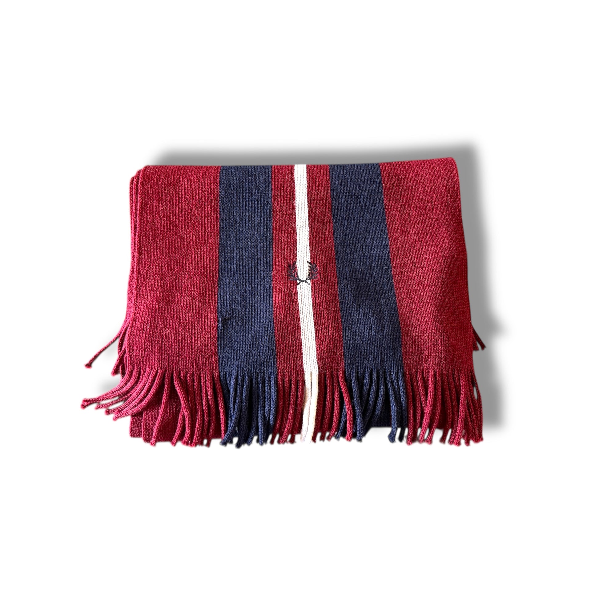 A folded Fred Perry scarf with a maroon and navy color scheme and fringed ends.