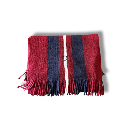 A folded Fred Perry scarf with a maroon and navy color scheme and fringed ends.