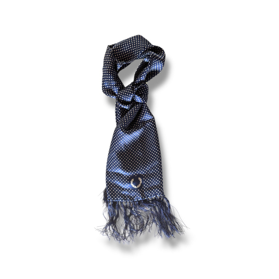 A silk scarf with a polka dot pattern in blue tones, tied around a virtual display mannequin's neck.