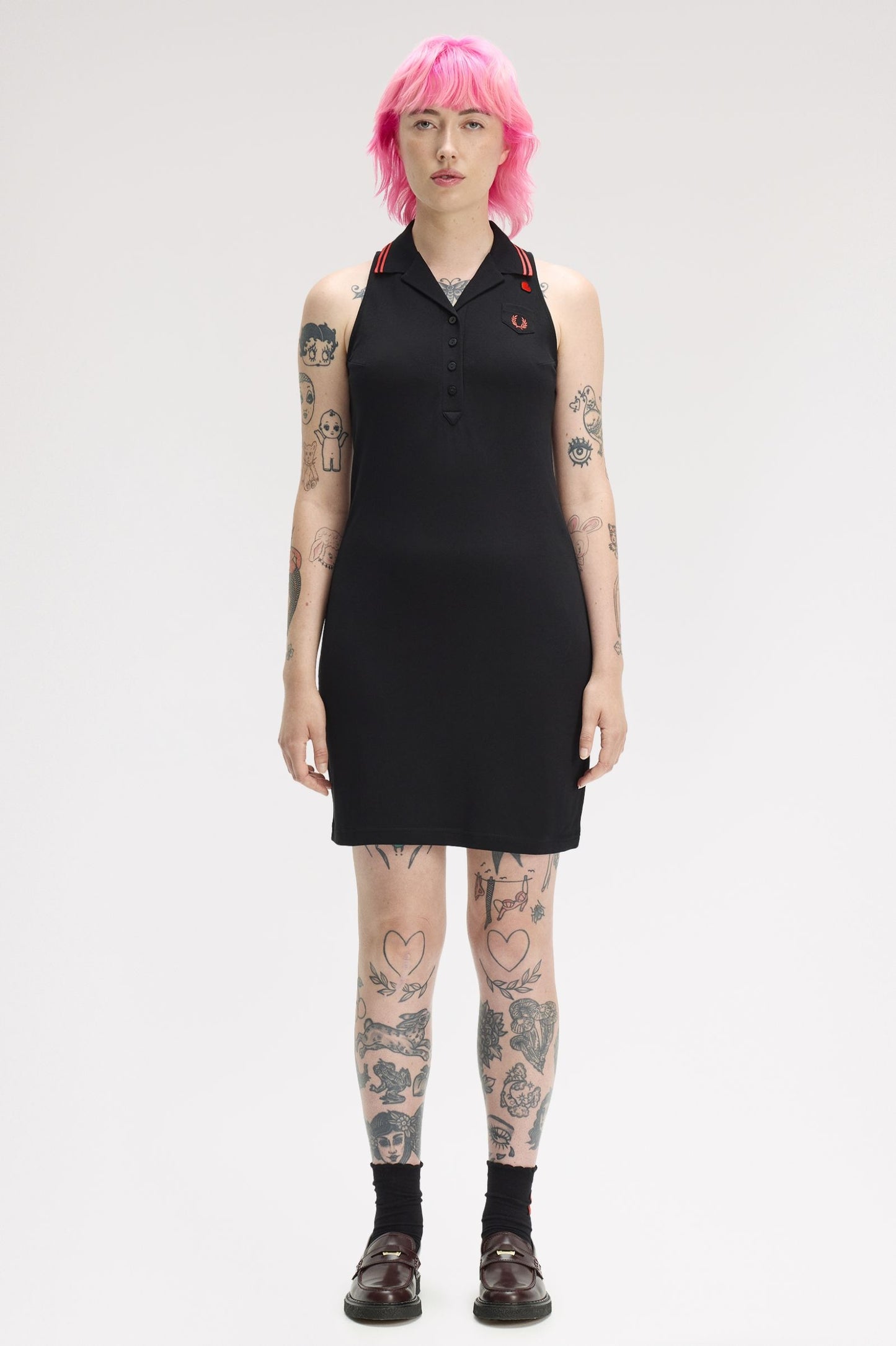 Person wearing a black sleeveless dress with a white background