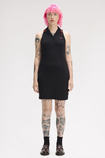 Person wearing a black sleeveless dress with a white background