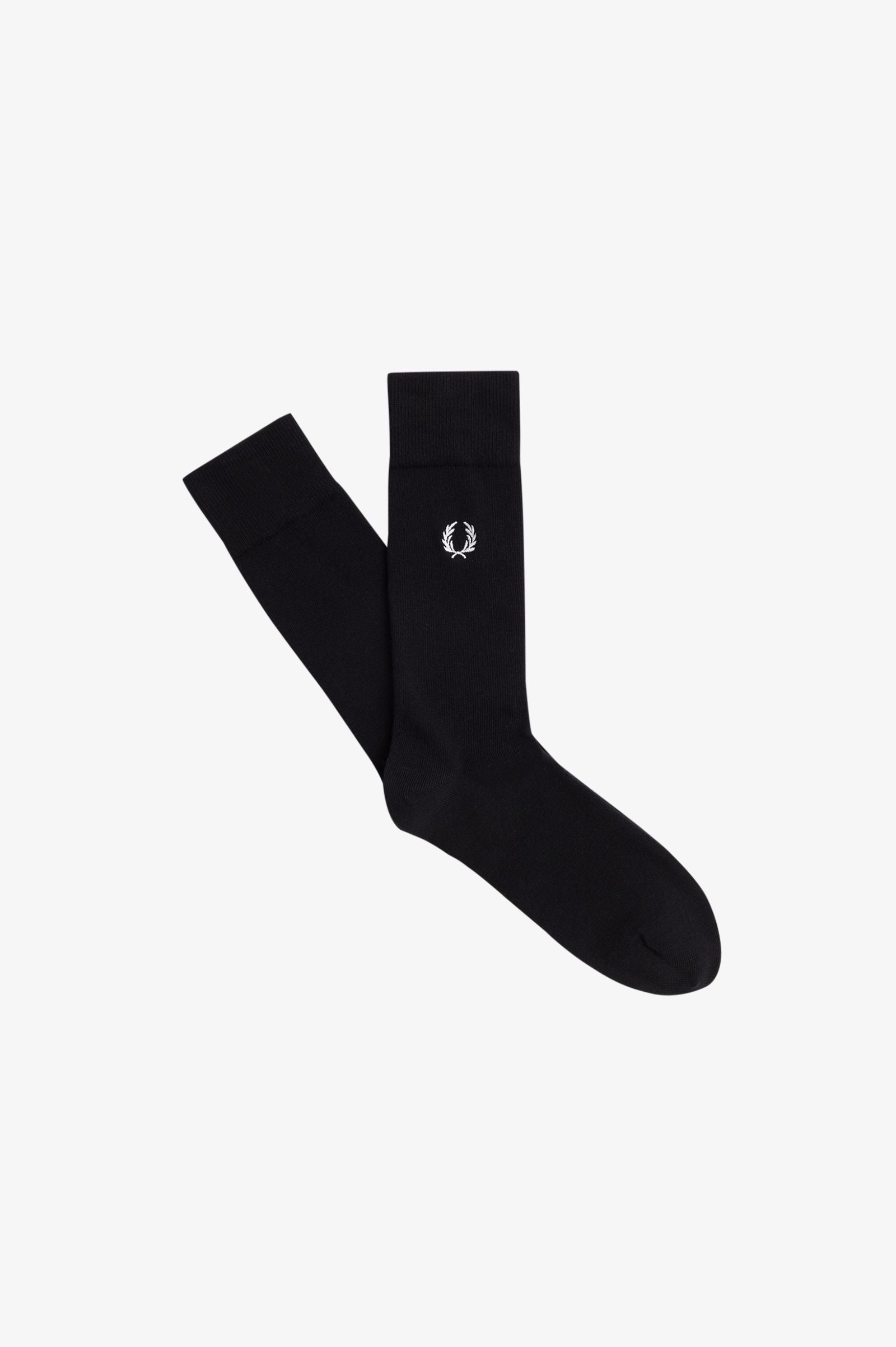 A pair of black Fred Perry socks with the brand's logo on the ankle area.