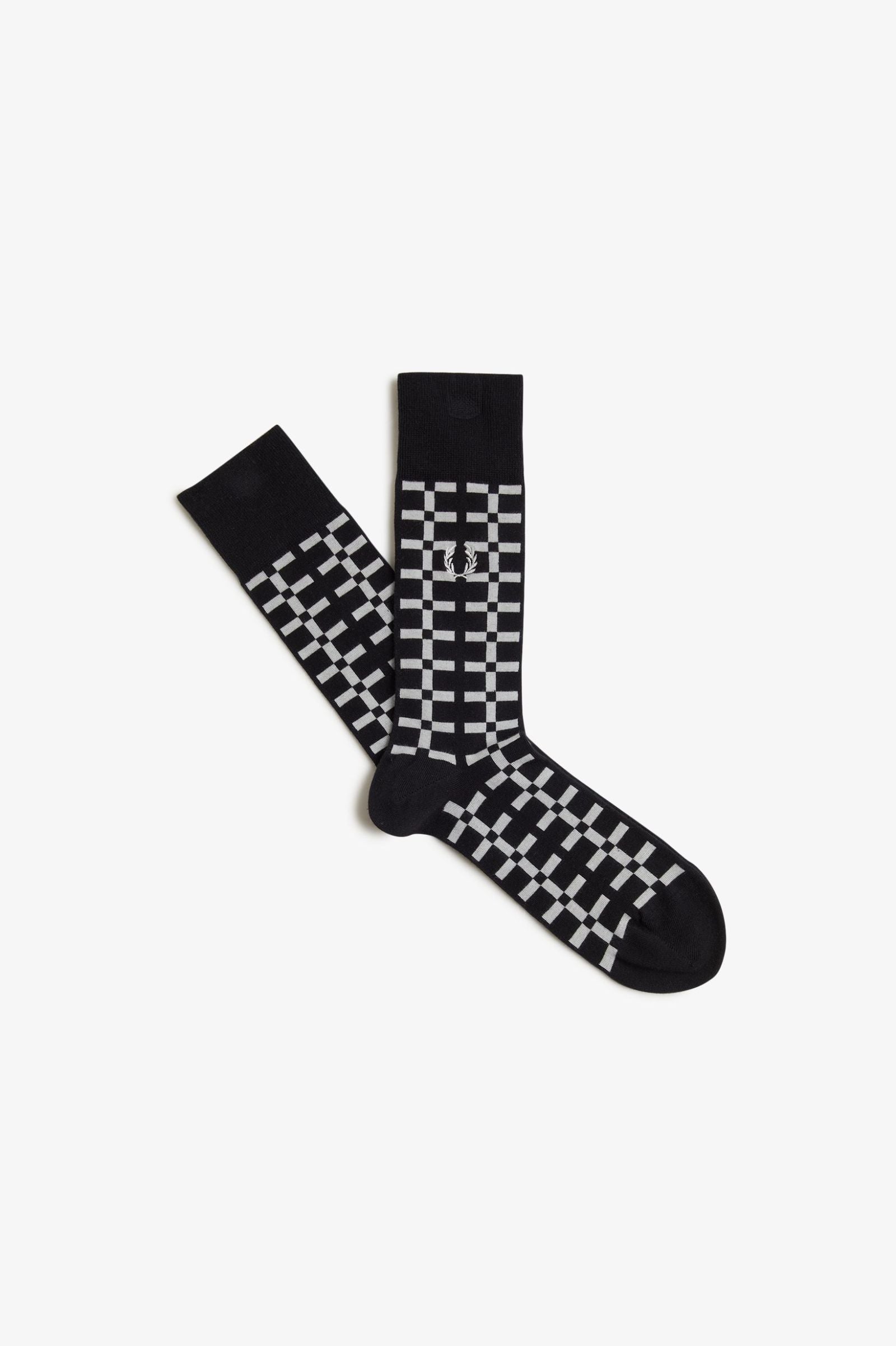 A pair of black Fred Perry socks with the brand's logo on the ankle area.