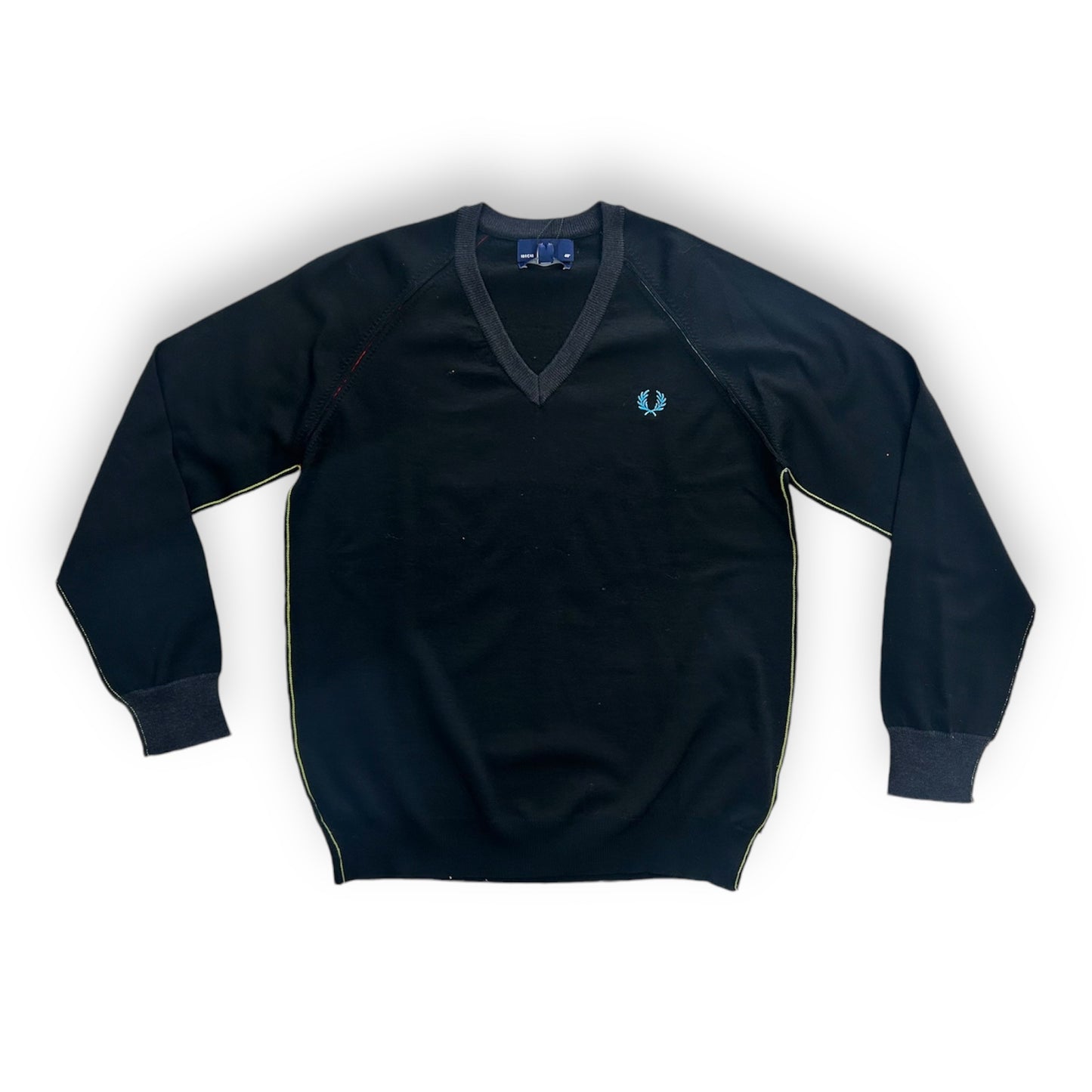 A black Fred Perry sweater with a V-neck collar and a small blue and yellow stripe on the sleeve.