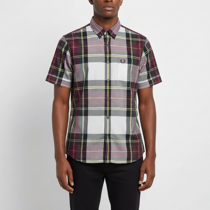 Person wearing a plaid short-sleeve shirt on a white background