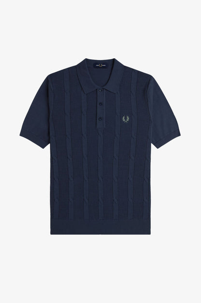 Navy blue polo shirt with a brand logo on a light gray background