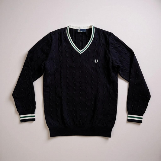 Black sweater with white trim on a light gray background