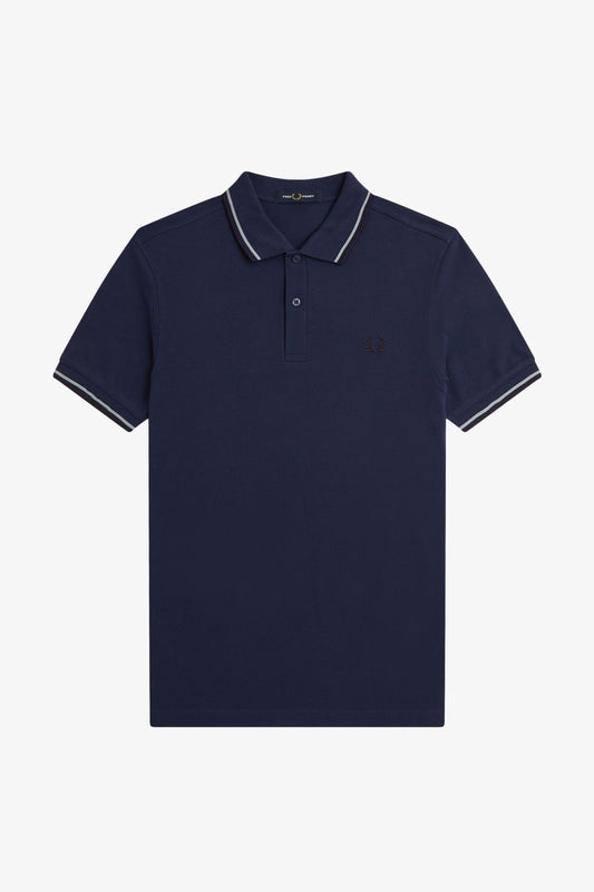 Navy blue polo shirt with white trim on a light gray background