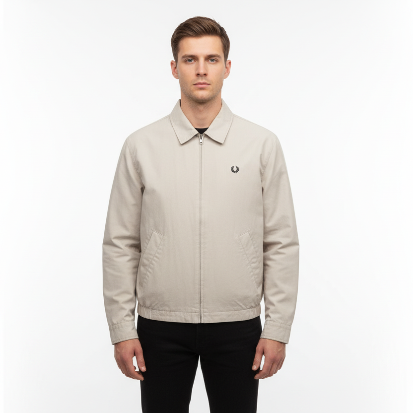 Man wearing a beige jacket with a brand logo on a white background