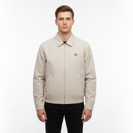 Man wearing a beige jacket with a brand logo on a white background