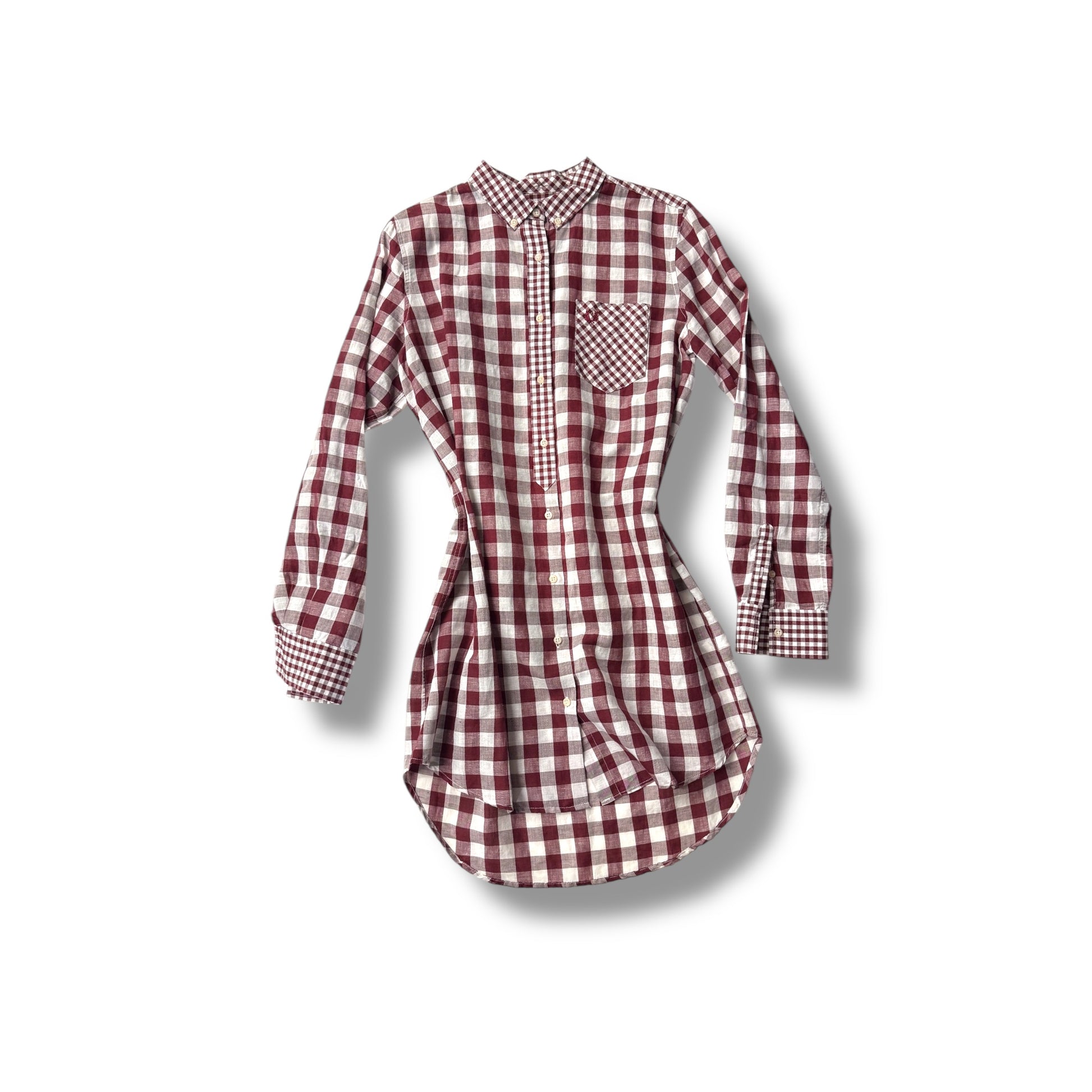 An oversized gingham print shirt with long sleeves and a collar, featuring a red and white checkered pattern.