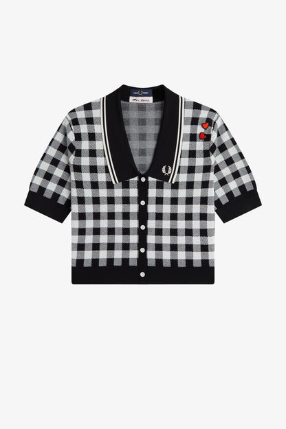Black and white checkered cardigan with a brand logo on a white background