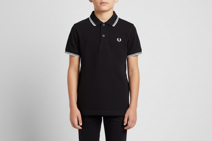 Person wearing a black polo shirt with white trim on a gray background