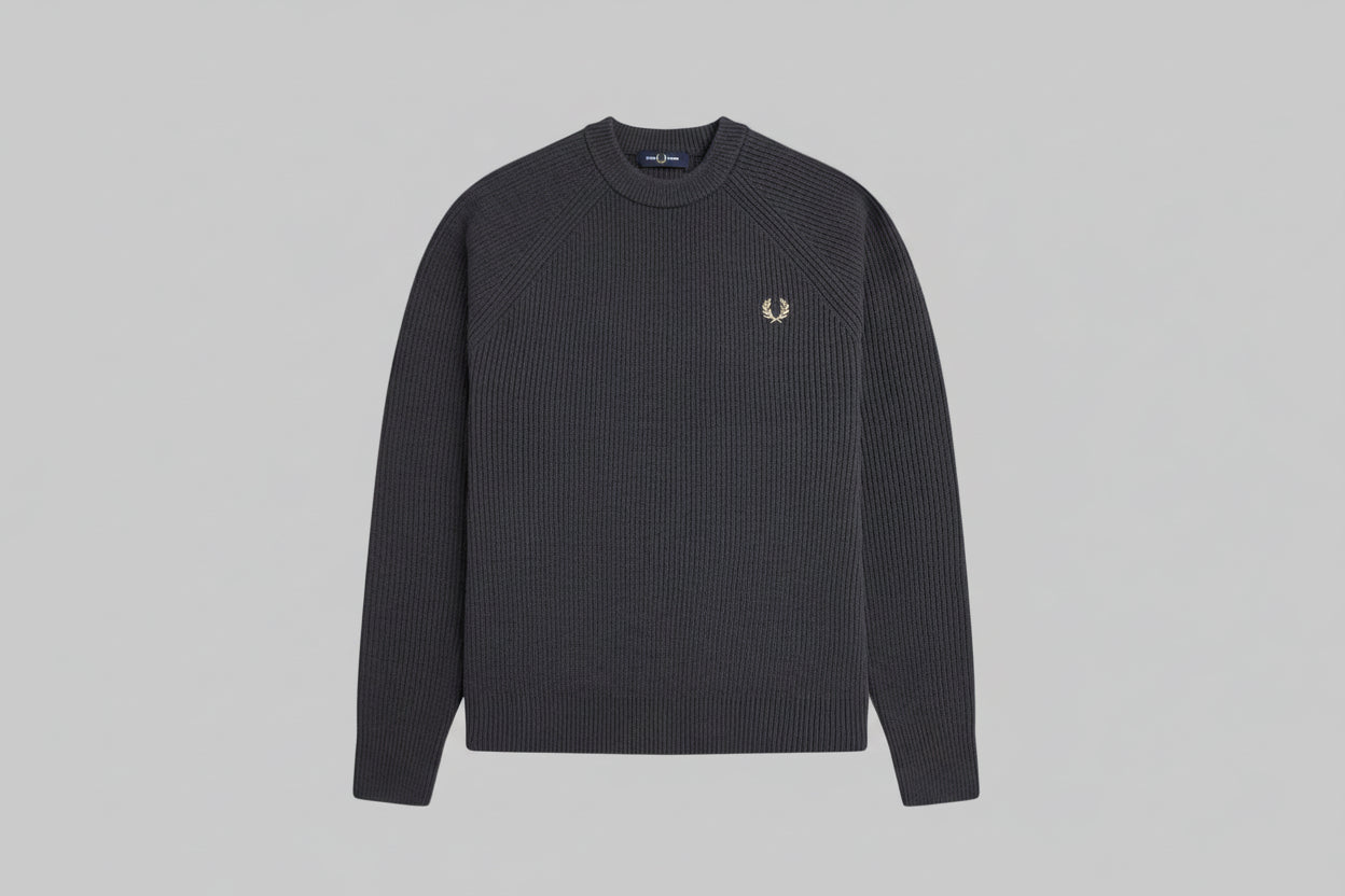 Black ribbed sweater with a brand logo on a light gray background