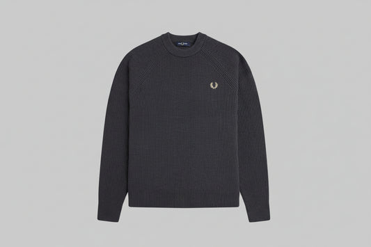 Black ribbed sweater with a brand logo on a light gray background