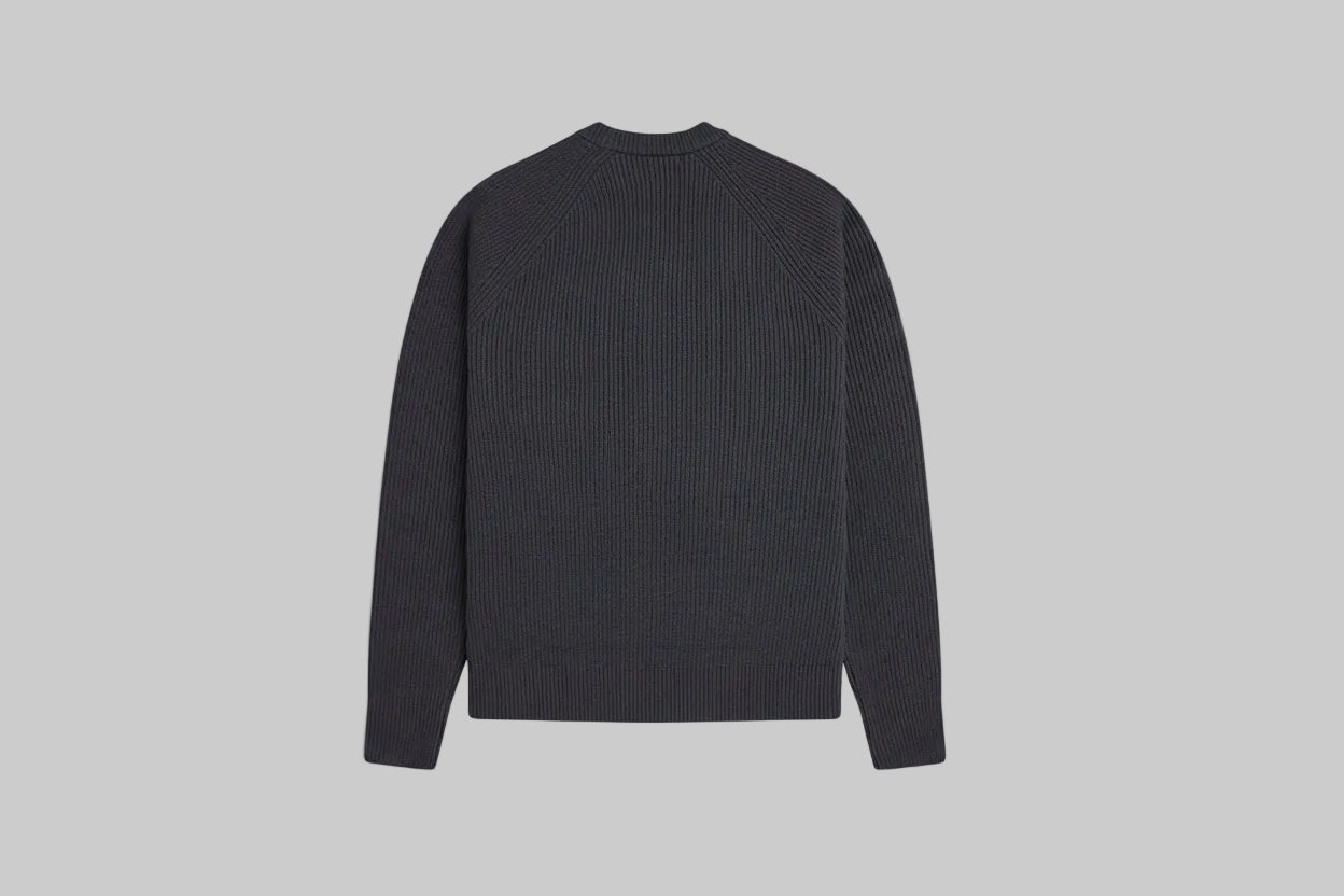 Black sweater on a light gray background