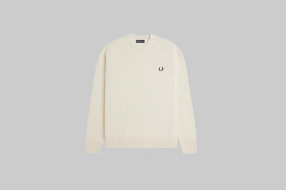 Cream-colored sweater with a brand logo on a white background