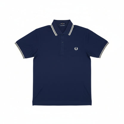 A folded blue Fred Perry polo shirt with white stripes on the collar and chest logo