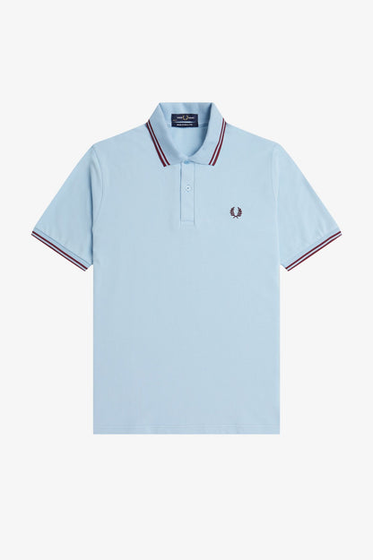 Light blue polo shirt with red and white trim on a white background