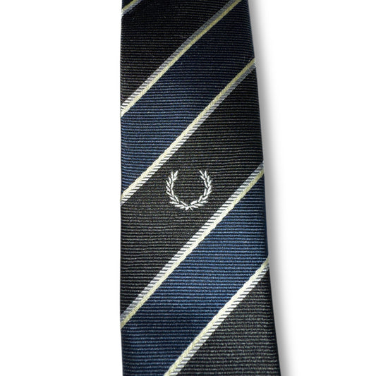 A striped necktie with a central logo, primarily in navy and black colors.