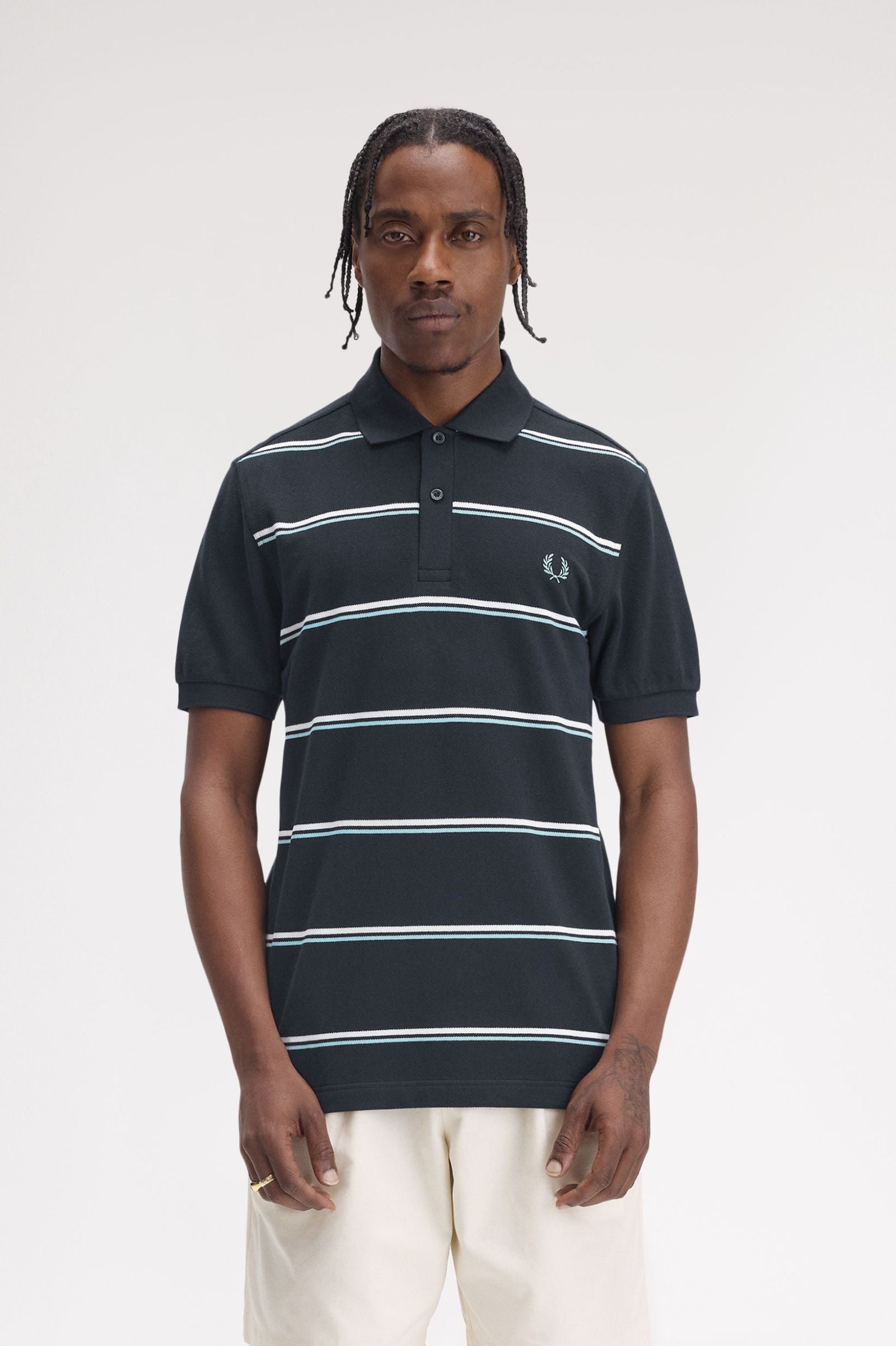 A person wearing a black and blue striped polo shirt with a collar.