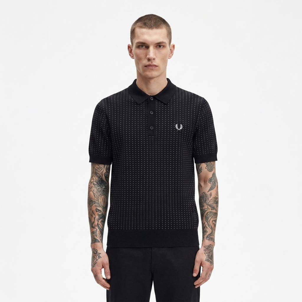 A man modeling a black short-sleeve polo shirt with a subtle micro-dot pattern and the iconic embroidered laurel branch logo on the chest, set against a plain light gray background.