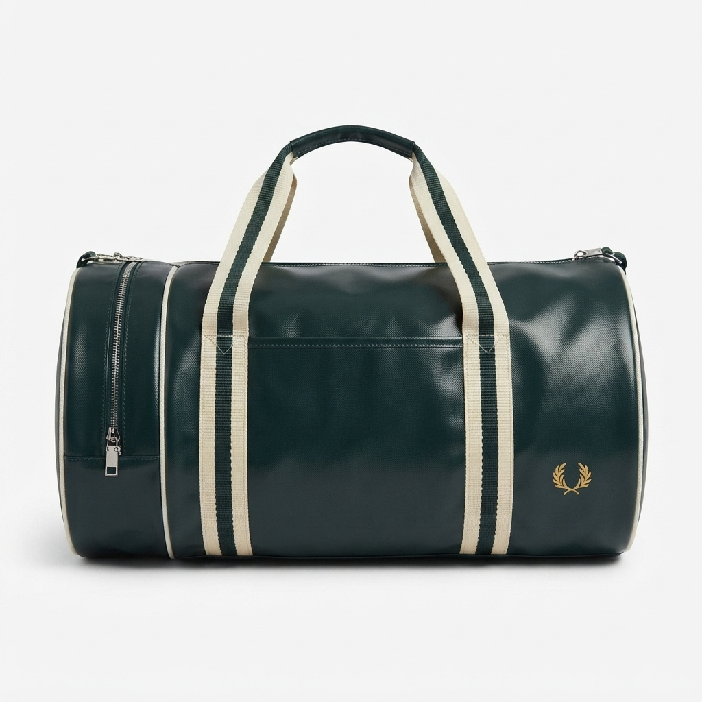 A dark green leather duffel bag with cream-colored vertical stripes on the handles and sides, featuring a gold embroidered laurel wreath logo on the front right and a zippered side pocket, set against a plain light gray background.