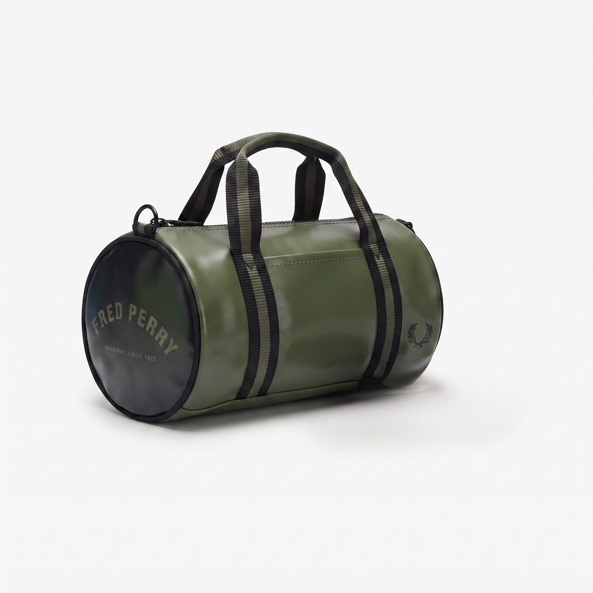 An olive green cylindrical duffel bag by Fred Perry, featuring black webbing handles, black side stripes, and a black circular end cap with gold lettering, set against a plain white background.