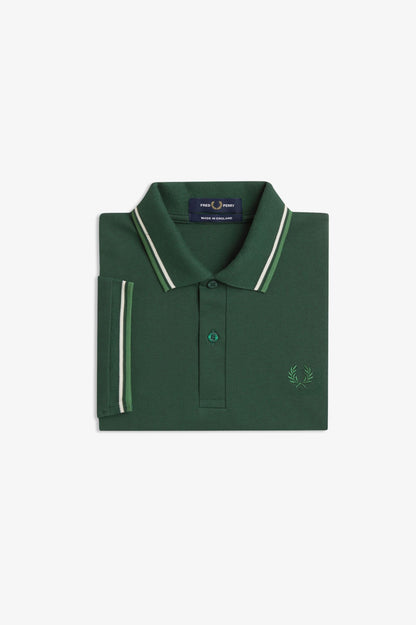A folded dark green polo shirt with white and light green striped trim on the collar and sleeve cuff, featuring a small embroidered logo on the chest, set against a plain white background.